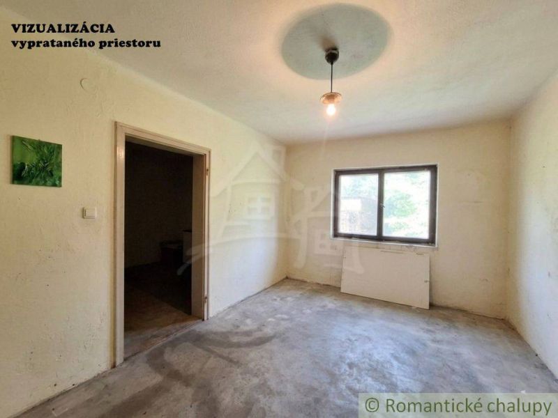 A room in a family house with a bare floor, a window, and lighting.