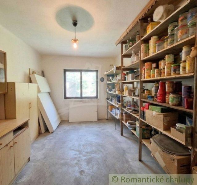 A pantry in a family house with shelves full of preserves and canned goods.