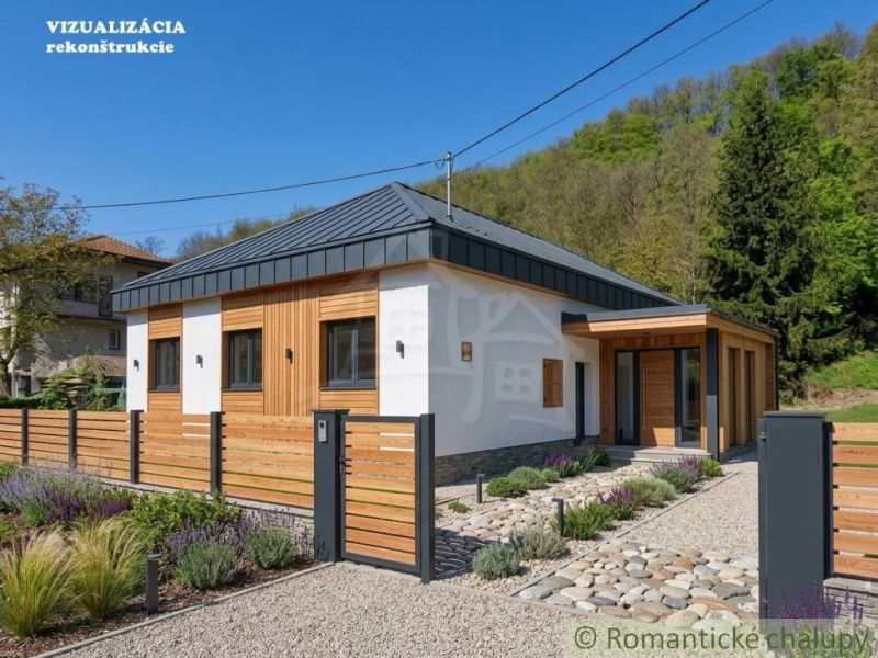 A family house in Šiatorská Bukovinka with wooden cladding and a landscaped garden.