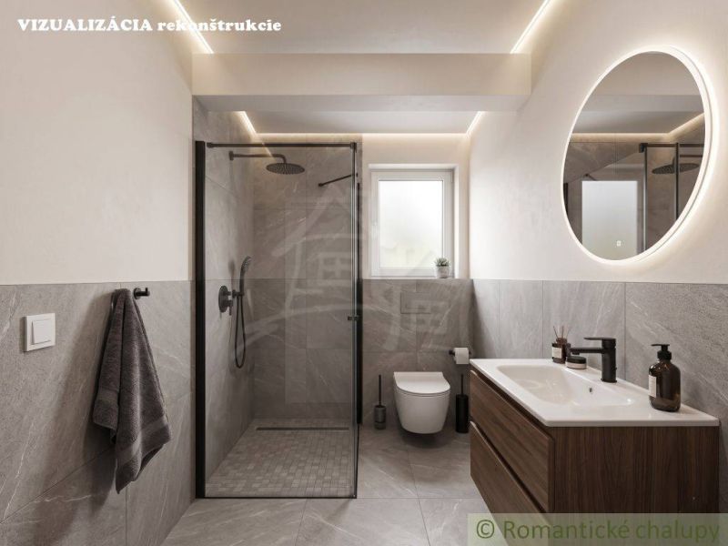 A bathroom in a family house with a large shower and a round mirror.