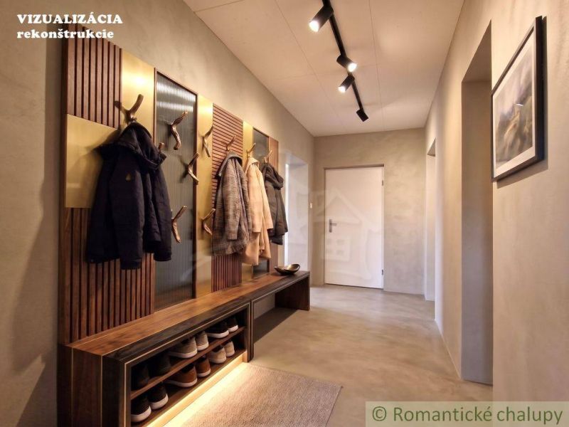 Entrance hall in a family house with coat racks, a bench, and lighting.