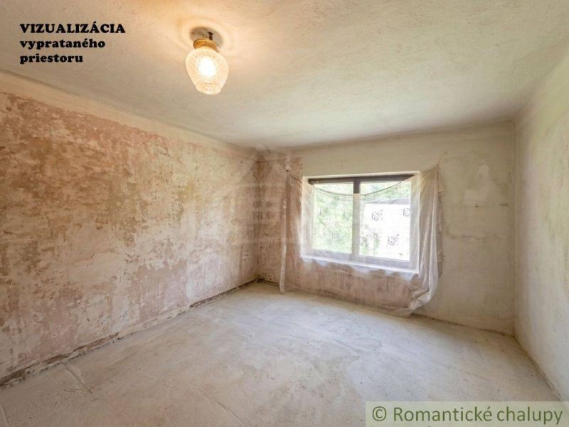 A parched room in a family house with unfinished walls and one window.