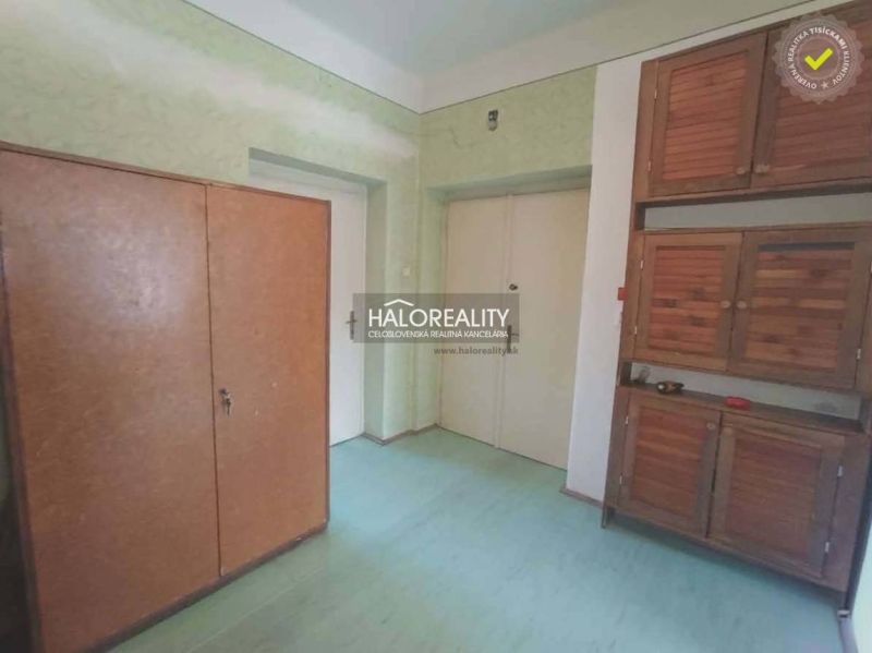 Interior of a 2-room apartment with wooden cabinets and a floor with a wood decor.