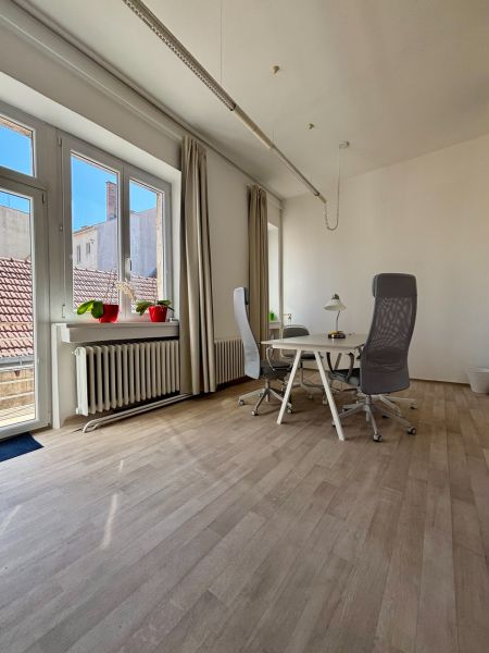 Bright office with wood-patterned flooring and a desk by the window, Hlavná, Trnava.