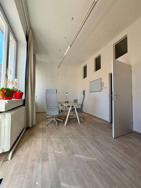 Offices with wood-patterned flooring, chairs, and a desk, view from the window.