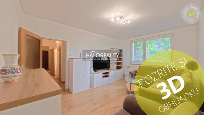 Living room in a two-room apartment with a wooden decor floor and a comfortable sofa.