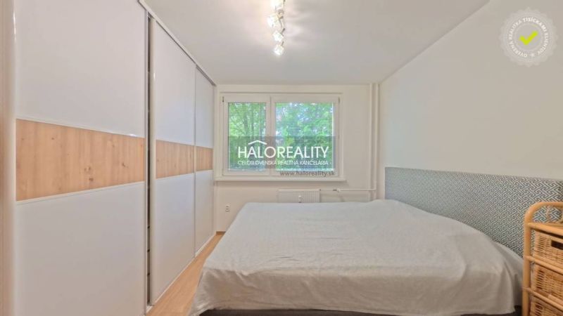 A bedroom with a built-in wardrobe and a double bed in a 2-room apartment.