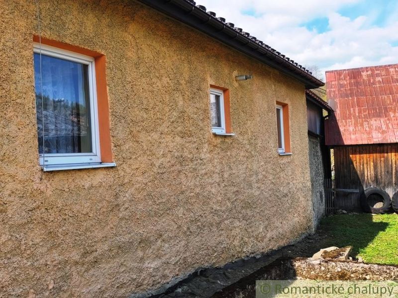 A family house in Reľov with simple plaster and two windows.