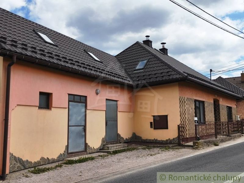 A family house in Reľov with a dark roof and attic windows.