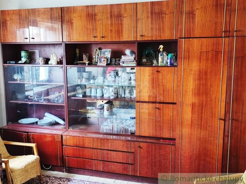 Furniture with glass display cabinets and wood decor in a family house, displaying dishes.