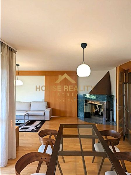 A living room in a 4-room apartment with a fireplace and a wooden decor floor.