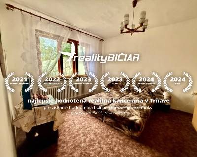 A bedroom in a family house with carpeted flooring and two beds, illuminated by a window.