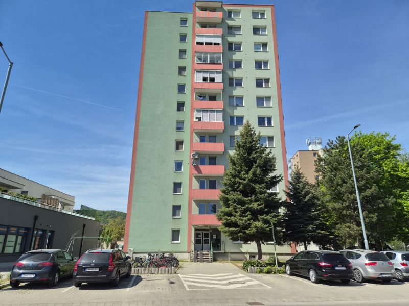 Apartment building in Trenčín on Pred poľom Street, with cars parked next to it.