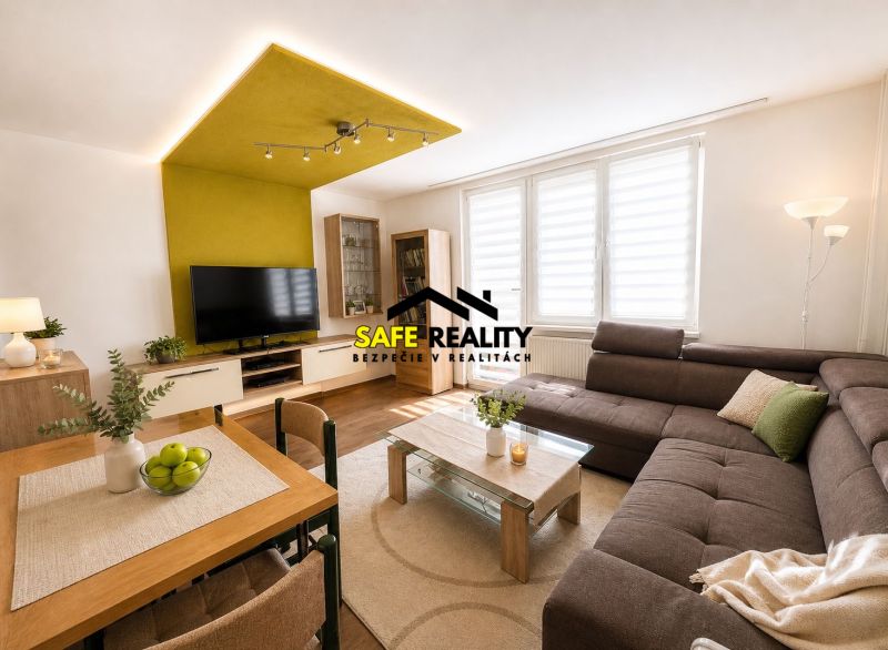 Spacious living room in a 3-room apartment with a corner sofa and a television.