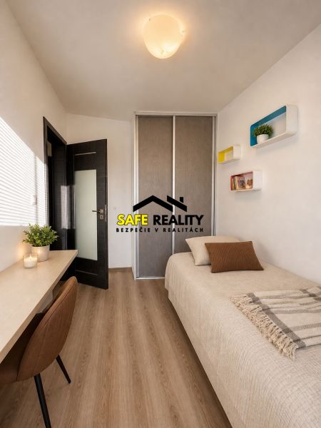 A single room in a 3-room apartment with a wooden decor floor.