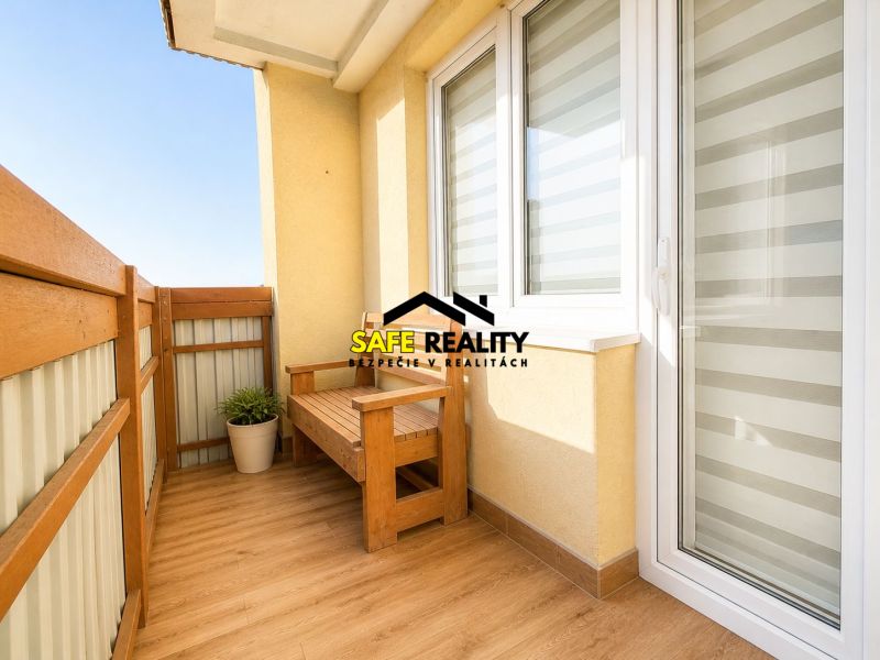 A balcony of a 3-room apartment with wooden seating and flooring with a wooden decor.
