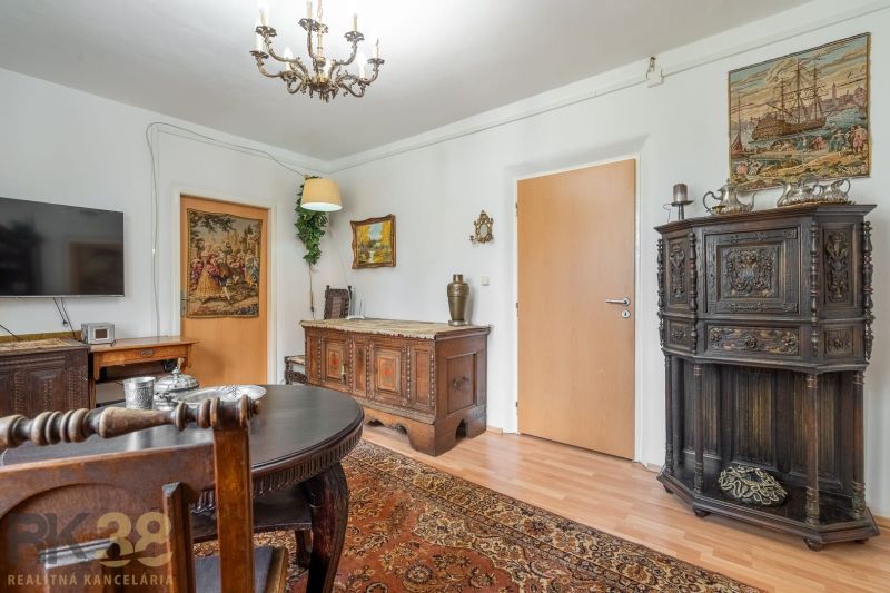 Living room with antique furniture and wood-patterned flooring in a 4-room apartment.