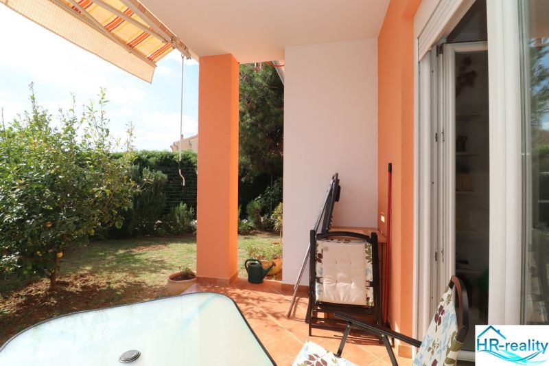 The terrace of a family house in Vodice with seating and a view of the garden.