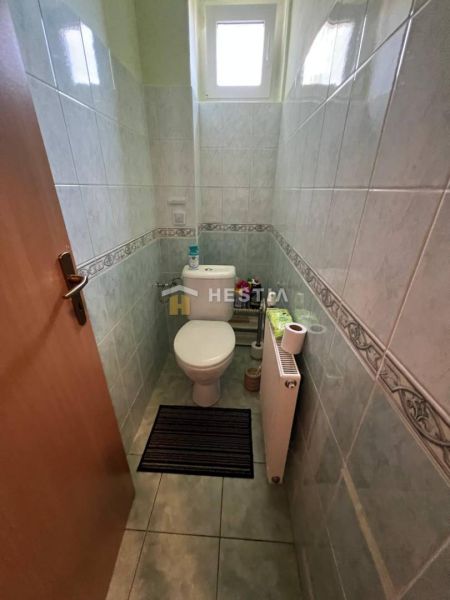 A bathroom with tiles and a radiator in a 3-room apartment.