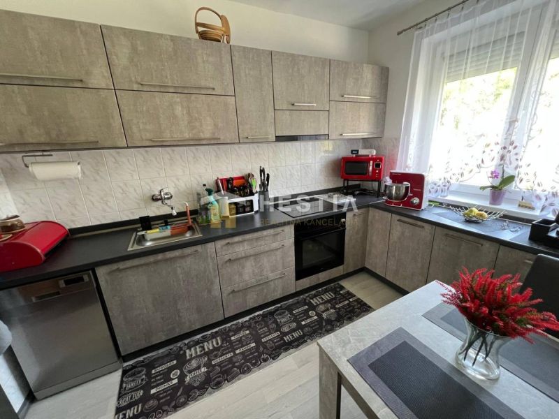 A kitchen with modern appliances and decorative elements in a 3-room apartment.
