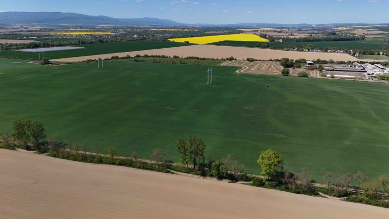 Aerial view of green fields surrounded by agricultural landscape near Trhovište.