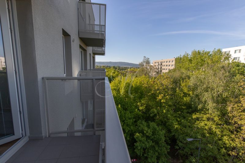 Balcony with a view of greenery and buildings in Bratislava, Ivanská cesta, 2-room apartment.