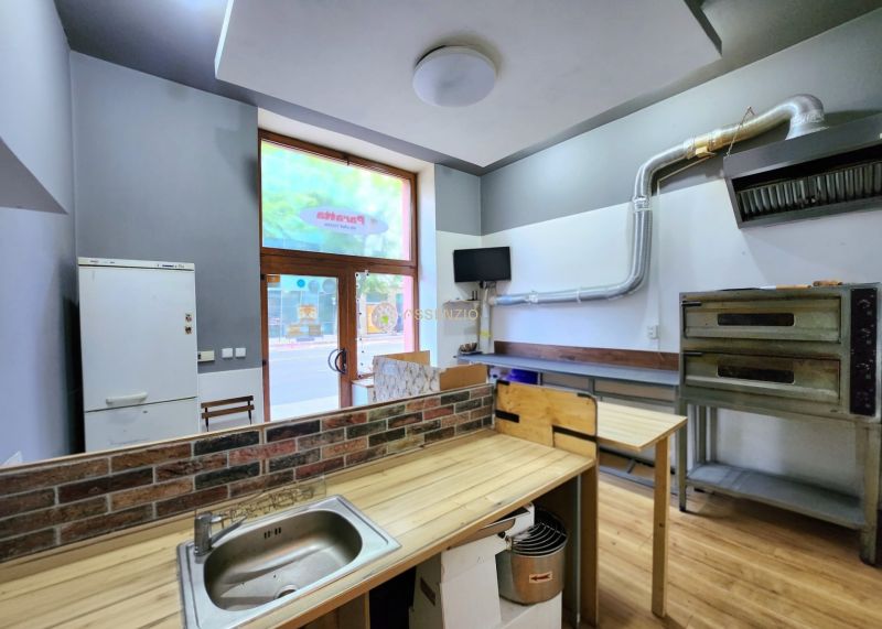Interior of gastro spaces with kitchen equipment and flooring with wood decor.