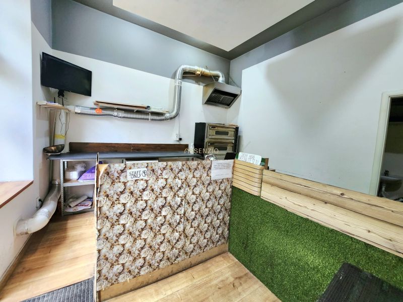 Interior of gastro spaces with wood-decor flooring and food preparation equipment.