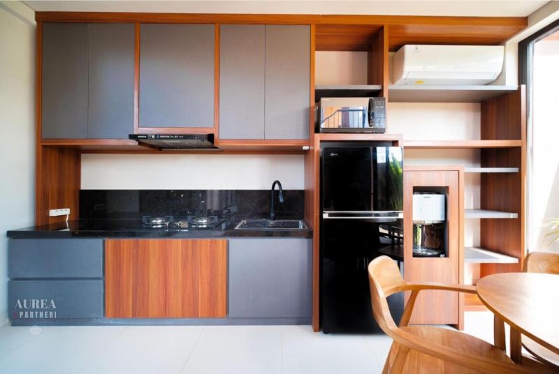 A kitchen in a villa with wooden decor, equipped with modern appliances and storage space.