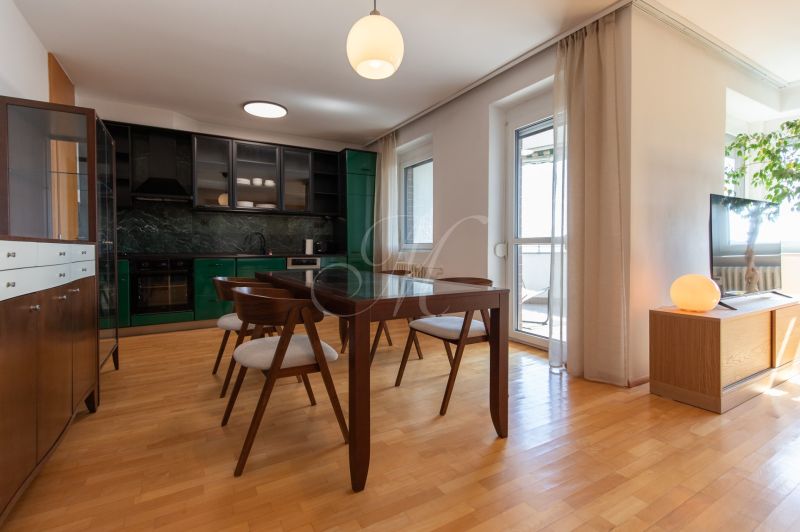 Dining area with wood-patterned flooring and a view in a 4-room apartment.