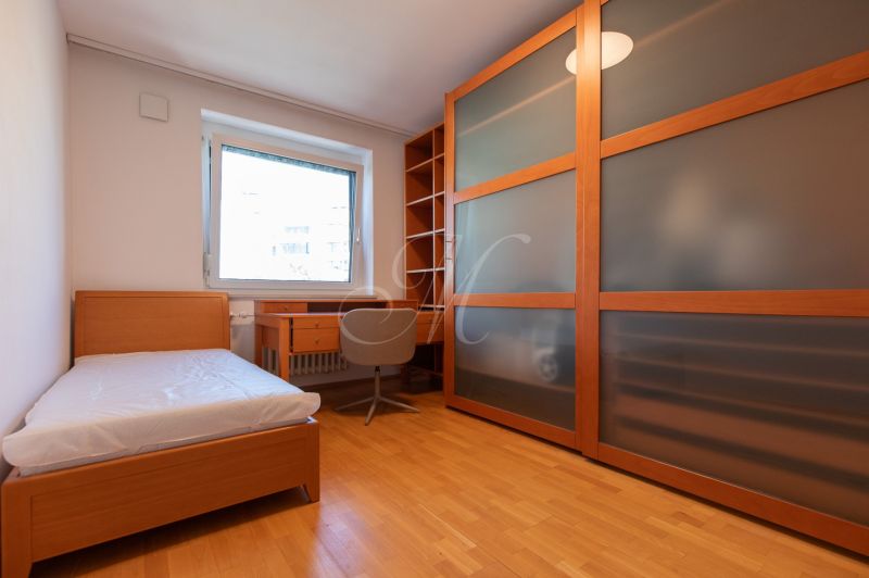 A room with a bed, a desk, and a built-in wardrobe in a 4-room apartment.