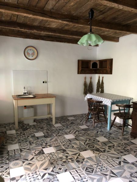 Interior of a family house with a retro tiled floor and a wooden ceiling.