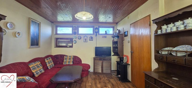 Living room in a cottage with a corner sofa and a wooden decor floor.