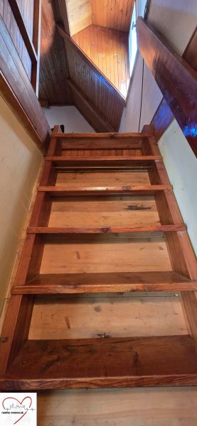 Wooden stairs and ceiling with wooden decor in the cottage.