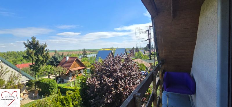 The view from the cottage in Suchá nad Parnou, Nové Vinohrady, over the green gardens and roofs.