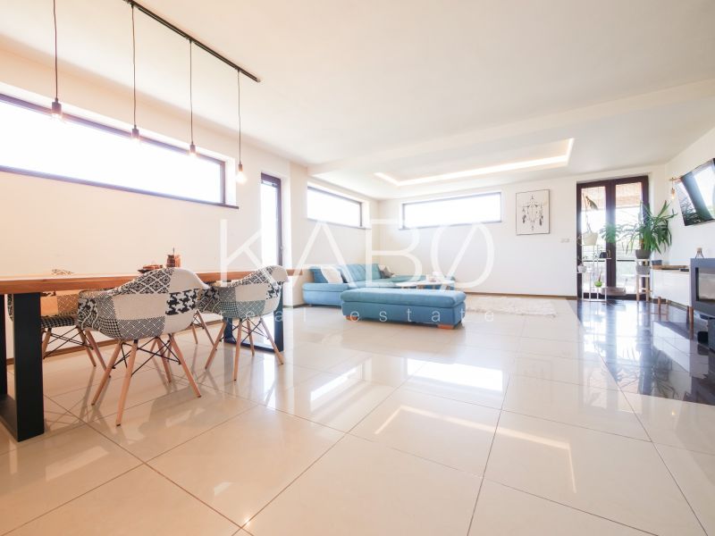 Living room with spacious tiles and a blue sofa in a family house.