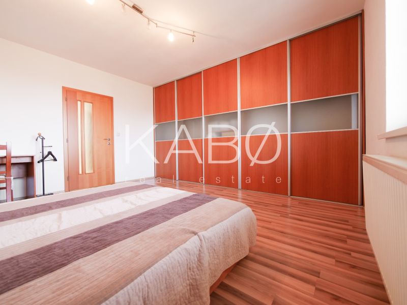 Bedroom in a family house with a built-in wardrobe and flooring with a wood decor.