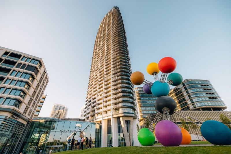 In Bratislava on Pribinova Street, there is a tall building with a colorful sculpture.