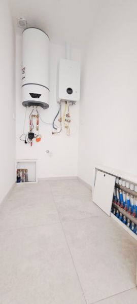 Boiler room in a family house with an installed boiler and water heater.