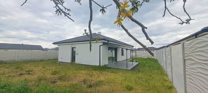 A family house in Topoľnica with a garden and terrace, surrounded by a decorative fence.
