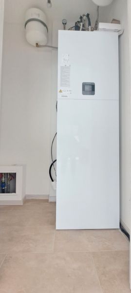 Boiler and expansion tank in the utility room of a family house.