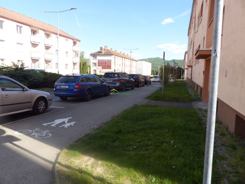 Parking lot and buildings by the road in Žiar nad Hronom near a 2-room apartment.