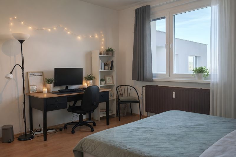 Bedroom with a desk, computer, chair, and shelf in a four-room apartment. Floor with wood decor.