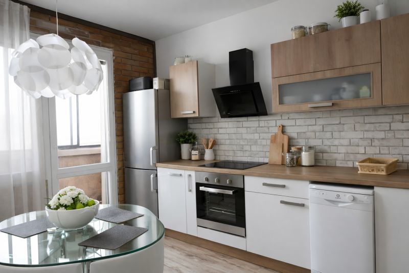A bright kitchen with appliances, a dining table, and a wooden decor floor in a 4-room apartment.