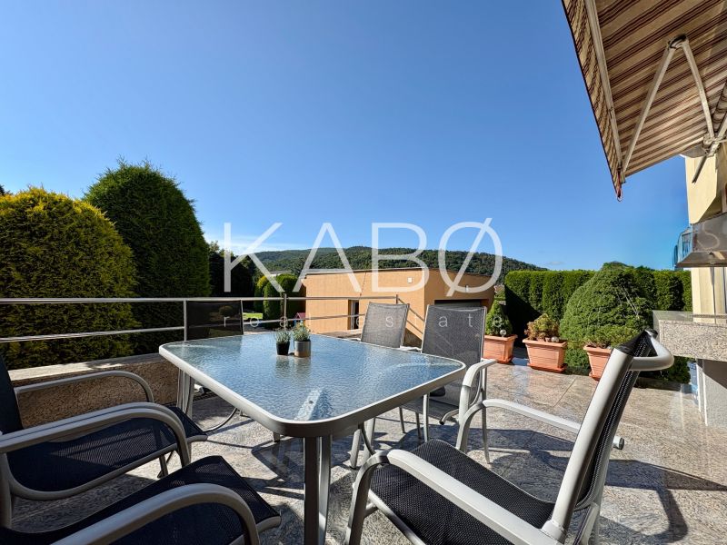 In Partizánske, a terrace of a family house with garden furniture and a view of greenery.