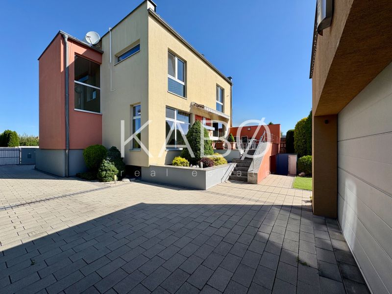 A family house in Partizánske with a garden, terrace, and garage on a paved yard.