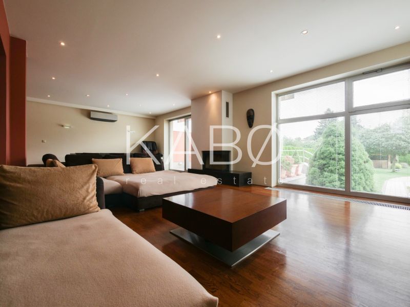 Living room in a family house with a large window and a wooden decor floor.