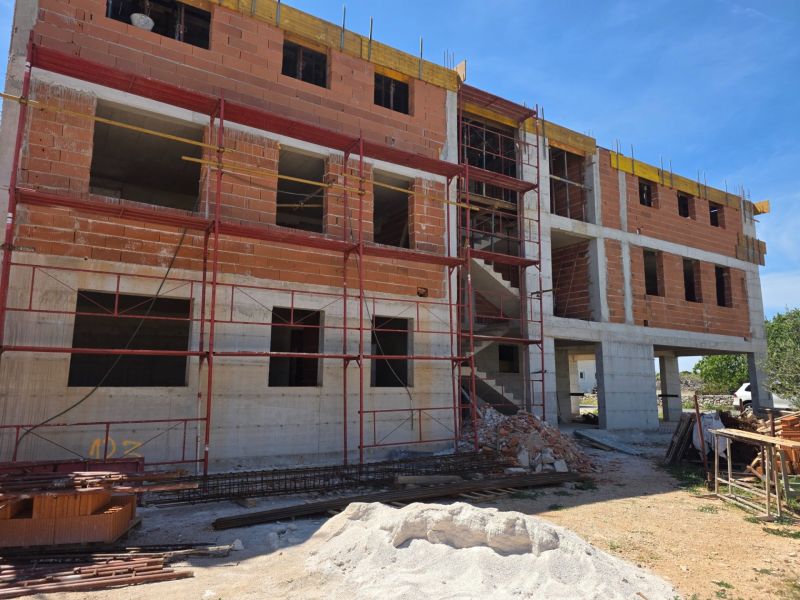 An unfinished 3-room apartment in the town of Srima with scaffolding and construction materials.