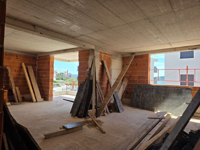 Interior design of a 3-room apartment in Srima with a sea view and brick walls.