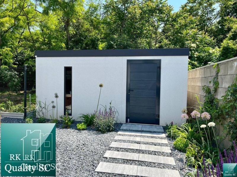 A family house in Senec with a modern garden and a stylish extension, surrounded by greenery.